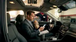 Professional eating lunch during oil change