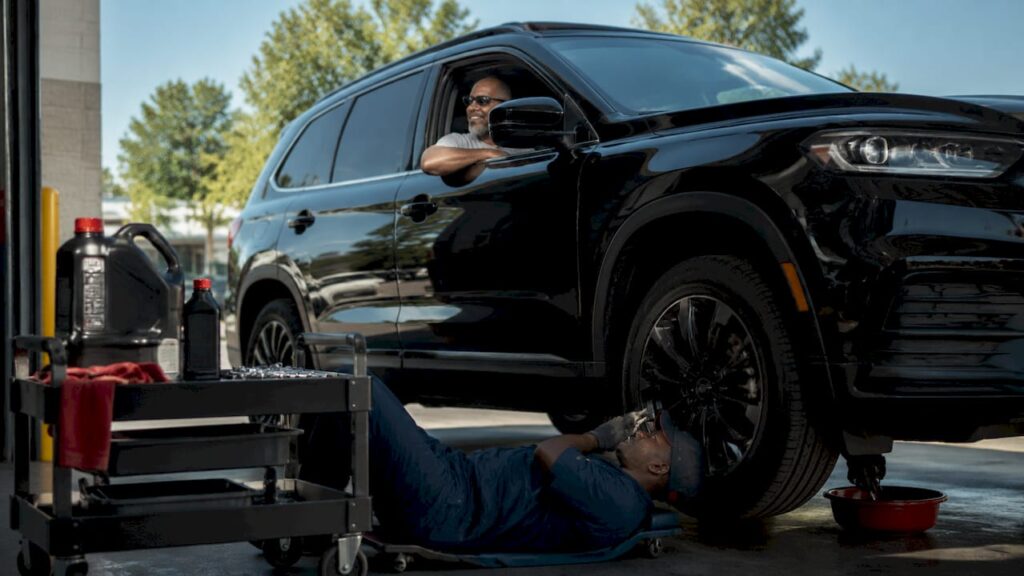 Driver seated in car during drive-through oil change