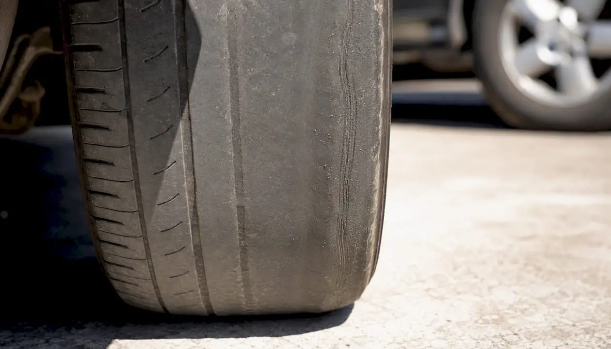 Close-up of tire with feathered misalignment wear