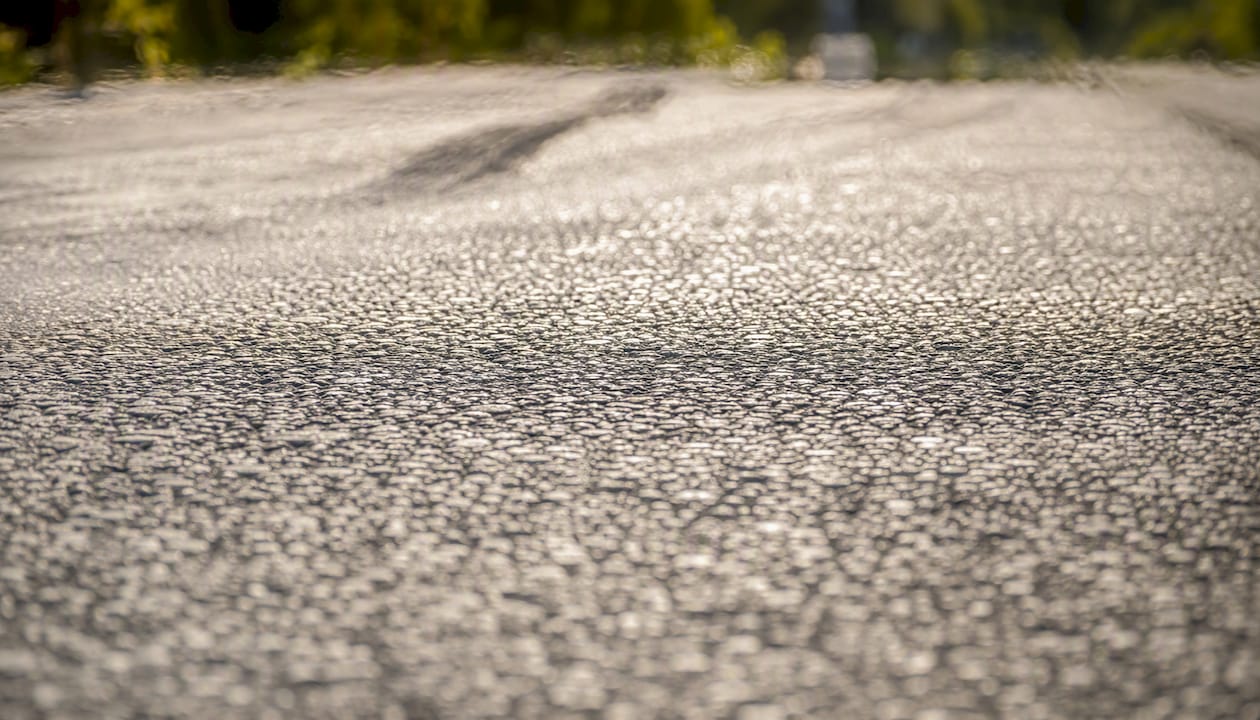Close-up of hot asphalt road surface with heat shimmer