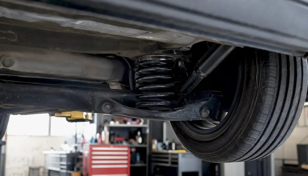 Compressed vehicle suspension springs under load