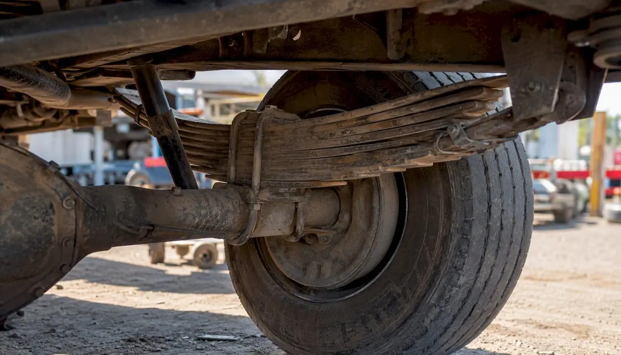 Vehicle leaf springs compressed under heavy load