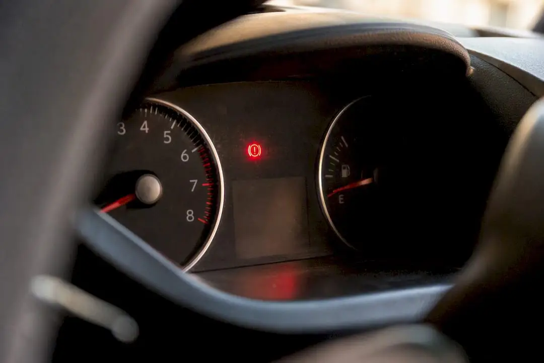 Glowing dashboard warning light in car interior