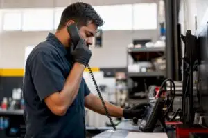 Technician using diagnostic tool and phone