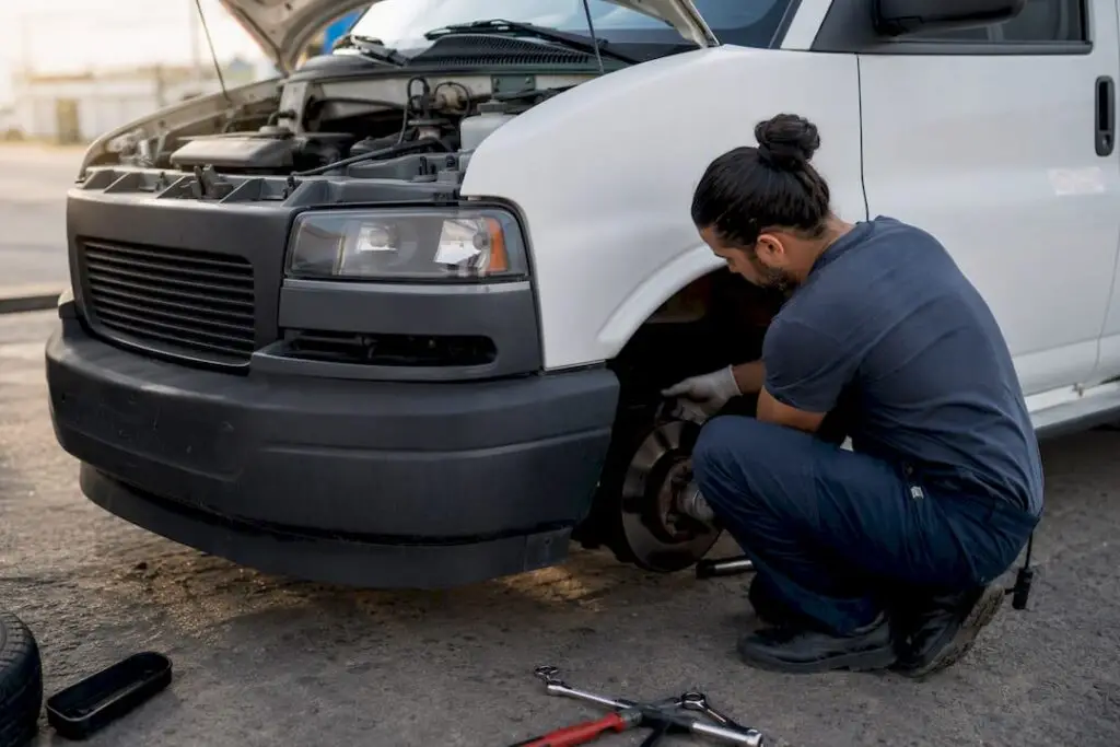 Technician performing preventive maintenance on fleet vehicle