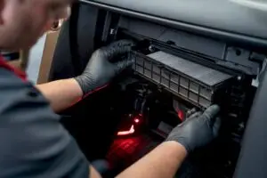 Technician inspecting a vehicle cabin air filter