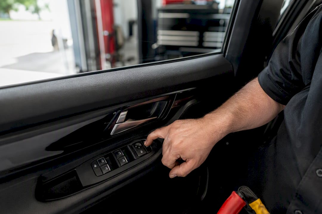 Technician testing driver door lock switch