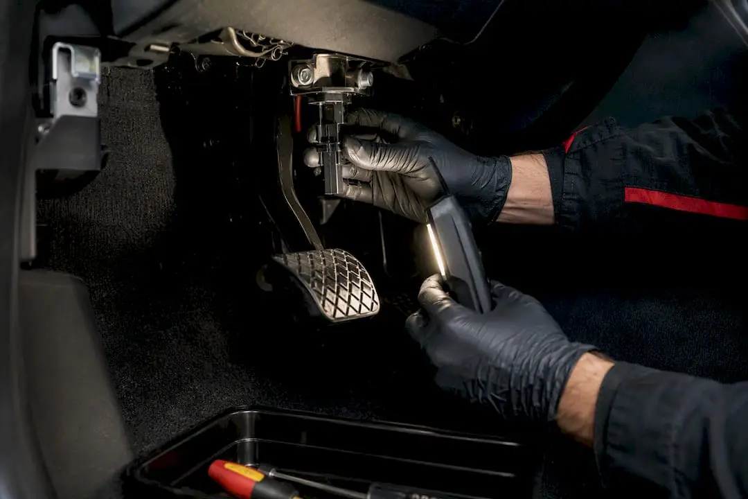Technician inspecting a brake light switch
