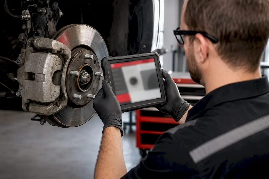 Technician documenting brake inspection findings