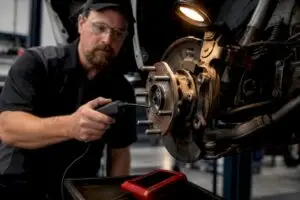 Technician diagnosing wheel bearing noise