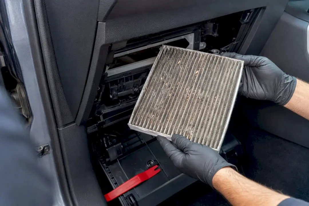 Technician checking a clogged cabin air filter