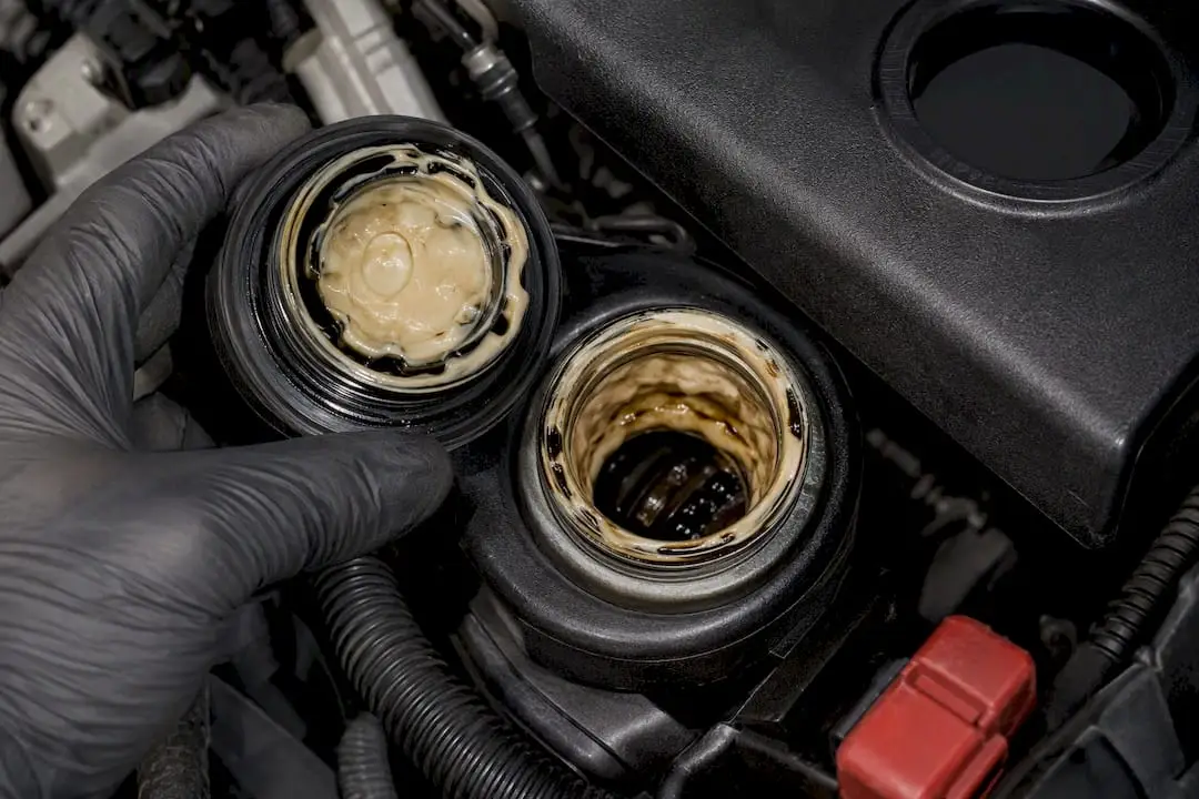 Creamy sludge visible under oil filler cap