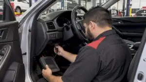 Technician scanning vehicle airbag system