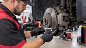 Technician measuring brake rotor thickness