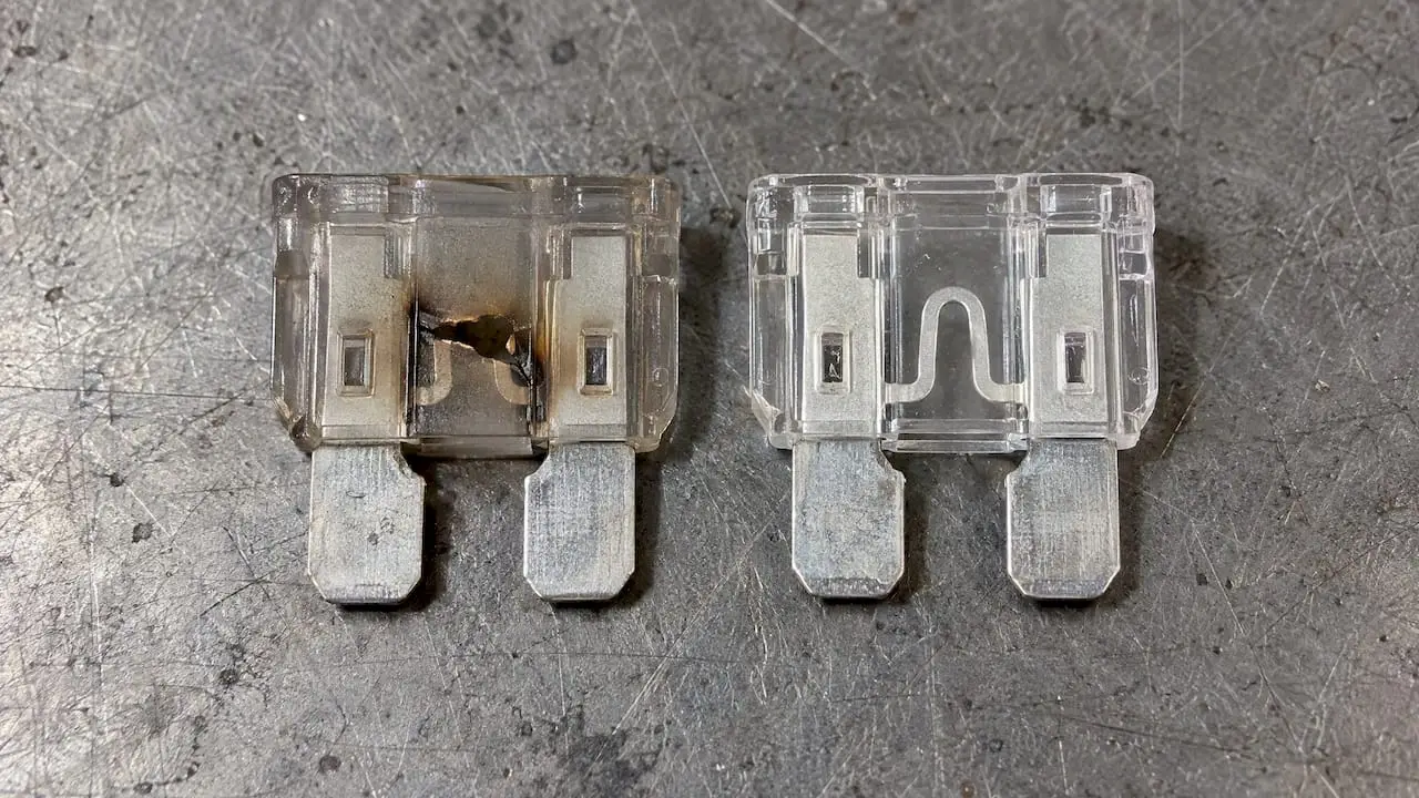 Blown fuse beside an intact automotive fuse