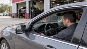 Driver trying to start a car at a repair shop